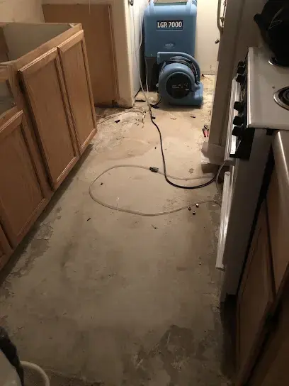 An LGR dehumidifier and air mover drying a kitchen floor after water damage, Gresham, OR